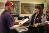Lawrence Hillman hands his ballot to Pat Fouts at Houston City Hall on Tuesday. Tim Rockey/Frontiersman/