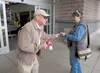 Veterans of Foreign Wars Post 9365 member Lloyd Smith hands out poppies made by disabled veterans for the Memorial Day weekend in Palmer Saturday morning. Smith will give away close to 2,000 