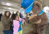 Christa Baird, 2, gets a welcome to the Governor’s Picnic Friday afternoon at Raven Hall on the Alaska State Fairgrounds in Palmer. ROBERT DeBERRY/Frontiersman.com