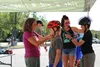 Julie Berberich tighten's Huck Bushatz' helmet. Tim Rockey/Frontiersman