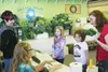 Mardie Robb and Gidget Sanders talk with a family about entering their vegetables in the 2014 Alaska State Fair. The fair continues through Sept. 1. HEATHER A. RESZ/Frontiersman