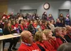 Local teachers wearing red attended the Mat-Su Borough School District School Board meeting Wednesday to voice their concerns about potential cuts to education. Jacob Mann/Frontiersman