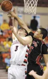 ROBERT DeBERRY/Frontiersman Wasilla Warrior Cole Schierman is
fouled as he tries for two points during first-round competition at
the ASAA/First National Bank State Basketball Championships i