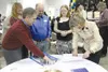 Gov. Sean Parnell and First Lady Sandy Parnell autograph a print
of an image by Steven Gordon titled, ‘Celebrating Alaska and our
Future’ that commemorates the Dec. 6, 2010, inauguration of
G