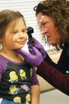 Michelle Rountree provides a mock examination for Olivia Venske, 6, at the Public Health Center during an open house March 31 at the Public Health Center. An immunization fair is planned at t