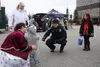 Wasilla police officer Nate Lecours handed out candy and took pictures with attending children and their families in front of a flickering police vehicle. Jacob Mann/Frontiersman