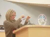 Licensed professional counselor and Wasilla High School teacher Deb Haynes demonstrates the calming effect of meditation using small gong cymbals at the Mat-Su ACES Summit conference. CAITLIN