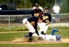 Palmer's Jeremiah Heikes is tagged by Homer third baseman Adam
Trieweggler during the Mariners' 5-4 win over Palmer on Thursday in
the first round of the Region III baseball tournament at Her