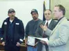 Tom Turner of the Alaska Department of Environmental
Conservation presents a pollution prevention award to the city of
Palmer public works department. From left, Paul Gibbs, Doug Walker
and R