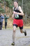 Wasilla senior Quincy Fuller makes his way down the muddy trail in the 4A boys race during the ASAA/First National Bank State-Cross Country Running Championships at Bartlett High School in An
