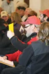 Tim Bauman bids on his properties Saturday afternoon at the Best Western Lake Lucille Inn. Bauman walked away with two lots of at least ten acres, having paid a total of $26,000. He said he m