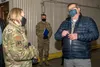 Donald Dougherty, a contracting officer assigned to the 673d Contracting Squadron, talks to U.S. Air Force Col. Kirsten Aguilar, Joint Base Elmendorf-Richardson and 673d Air Base Wing command