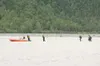 The Mat-Su Borough Dive and Rescue Team escorts a group of Boy
Scouts to a waiting boat on the Knik River Thursday afternoon. The
group became stranded when their canoes hit a sandbar 200 yar