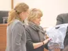 ROBERT DeBERRY/Frontiersman Palmer Assistant District Attorney
Alison Collins, left, and Alaska state crime lab forensic scientist
Kristin Denning examine evidence during the Frank Adams murd