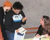 Novelist Eowyn Ivey, right, signs a copy of her new book “To the Bright Edge of the World” for fans during Tuesday night’s book release party at the Palmer Train Depot. MATT HICKMAN/Frontiers