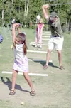 Rynae Baca and her coach Zack Gavlak take a swing at the
Settlers Bay driving range. Photo by JEREMIAH BARTZ/
Frontiersman.