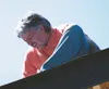 Bob Field works on the roof a Habitat for Humanity home that
will be purchased by Lida Mayo. Field first heard of HFH from his
parents when he was much younger. Photo by AMY
MENEREY/Frontiers