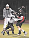 A Colony defensive lineman forces a fumble from Juneau
quarterback Phillip Fenumiai during the Knights’ loss to the
Crimson Bears in Juneau on Friday night. The loss was the first for
the Kni