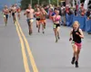 Palmer's Wren Spangler beats a pack of runners to the line to finish second in the girls race at the Mount Marathon Race on Thursday, July 4, 2024, in Seward. Jeff Helminiak/Peninsula Clarion