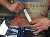 Alaskan Sweet Vapes employee Mark Lords shows off a high-end vaporizer on display in the Wasilla store on Wednesday, August 26, 2015. The Mat-Su Borough Assembly recently passed a measure tha