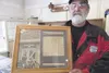 Classic motorcycle shop owner Ron Harvey holds a newspaper
article from when he first opened his shop 16 years ago in Palmer.
Harvey closed his doors for good Friday. (ROBERT
deBERRY/Frontier