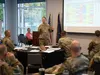 U.S. Air Force Col. Michael Fea, commander of the 673d Medical Group and director of the Alaska Market, presents analytics to medical leadership in the Defense Health Agency’s Alaska Market, 