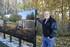 Denny Hamann stands near the new memorial wall recently installed at the Palmer Pioneer Cemetery. Jacob Mann/Frontiersman