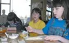 Catherine Mauldin, 9, right, works on her hot pocket at the
Pint-Size Cooking Workshop, which is conducted every Saturday
morning at Allen &amp; Petersen in Wasilla. Catherine's twin
sister, 