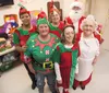 Santa and Mrs. Clause stand with their helper elves, from left, Mary Fuller, Theresa Fuller, Sue Sprague and Debbie Plesh inside the Am Vets Post 11 Santa Workshop Friday afternoon. Theresa F