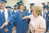 ROBERT DeBERRY/Frontiersman Jolene Grover checks senior Mike
Heath for graduation contraband — like blow-up beach balls and
silly string — before the start of Thursday’s ceremony at Palmer
Hi