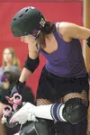 Dizzy-D tightens the trucks on her skates before the start of
practice. ROBERT DeBERRY/Frontiersman