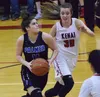 Palmer guard Sophia Benshelter eyes the rim with Kenai's Brooke Satathite defending Friday night at Kenai Central High School. Joey Klecka/Peninsula Clarion
