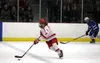 Wasilla's Karson McGrew skates the puck down the ice during an overtime win over Palmer. Bruce Eggleston/matsusports.net