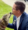 Mat-Su Regional Medical Center COO James Bunch, gets a little puppy love from Dingey, one of Outreach22's dog team during the Dog Days of Sumer event on July 9. The fun continues on Saturday,