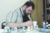 Artist Michael Powell paints light switch covers at Mat-Su
Services for Children and Adults Friday afternoon. At top right is
a finished cover depicting an Eskimo scene. Photo by Casey
Ressle