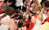 Wasilla head coach Katie Oxspring celebrates with her players after the Warriors earned their second straight state volleyball title. Bruce Eggleston/matsusports.net