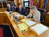 Rep. DeLena Johnson, R-Palmer and co-chair of the House Finance Committee, signs the committee's version of the state operating budget on Friday, April 5, 2024. Looking on is Rep. Neal Foster