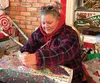 “I like wrapping presents, so this is something I enjoy volunteering to do,” said volunteer wrapper Kim Burke, who has been helping shoppers and gift-givers wrap their presents for 4 years as