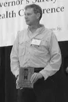 Pete Carter, president of the Alaska Avalanche Information Center, accepts an award at the Governor's Safety Conference on behalf of the Alaska Avalanche Information Center. AAIC operates the
