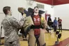 Harmon Sullivan, an 8th grader, removes an Air Force bomb suit, exhausted after a physical challenge for a school assembly at Central Middle School in Anchorage, Alaska, Dec. 13, 2017. The 67