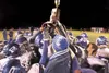 ROBERT DeBERRY/Frontiersman The Palmer football team gathers
around the Potato Bowl trophy.