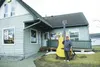 Hank Hartman poses for a picture next to a 12-foot guitar outside Matanuska Music. Large-scale art like the guitar would face additional scrutiny under a proposed downtown overlay district. B