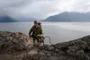 U.S. Air Force Capt. Travis Hunt, the commander of Detachment 1, 3rd Air Support Operations Squadron, Joint Base Elmendorf-Richardson, conducts mountain maneuvering training at Sunshine Ridge