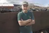 Sutton resident Jim Tapley stands in front of an old rail car
loaded with coal in front of the Alpine Inn in Sutton. Tapley
thinks that mining in the area can be done responsibly and could
be
