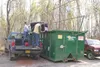 Joe Meehan, Lands and Refuge project coordinator for the state
Department of Fish and Game, helps Alaskans for Palmer Hay Flats
member John Abshire tip a couch into a Dumpster. Fish and Game,