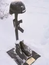 A Battlefield Cross Memorial was placed by the flagpole near the
entrance of the school on the 10-year anniversary of the death of
Wasilla High School alumnus Ronald John Hemenway. ET1 Hemenw