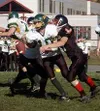 Houston's Steven Dubose (above) notches a sack Saturday against
Seward. Dubose caused a fumble on the play. Peter Clemens (below)
looks to deliver a pass in the third quarter. Photo by JEREMI