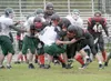 JEREMIAH BARTZ/Frontiersman A group of Houston Hawks make a
tackle against Delta last Saturday.