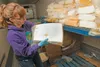Alaska Department of Natural Resources Division of Agriculture revolving loan fund officer Amanda Swanson inspects cheese before disposing of it Thursday afternoon at the Matanuska Creamery l
