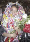 Virginia Aumavae is buried with love by her extensive family
after receiving her diploma. (K.T. McKEE/Frontiersman)